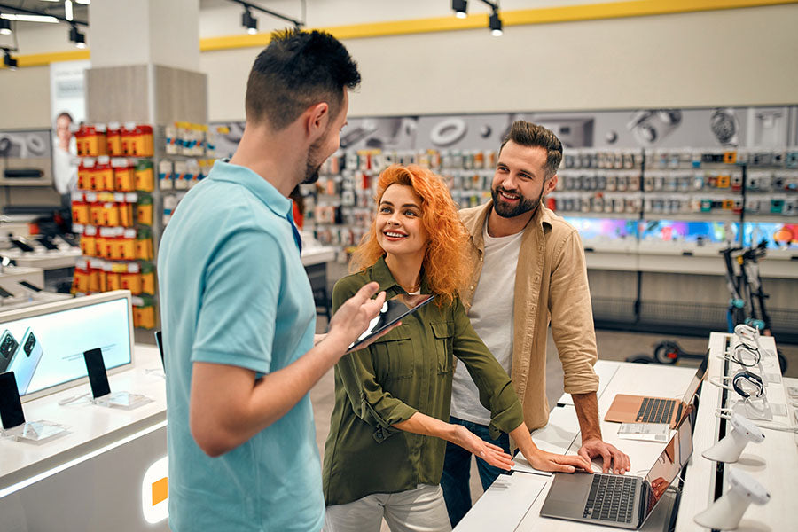 Customer receiving cash offer for electronics at PayMore Cumberland