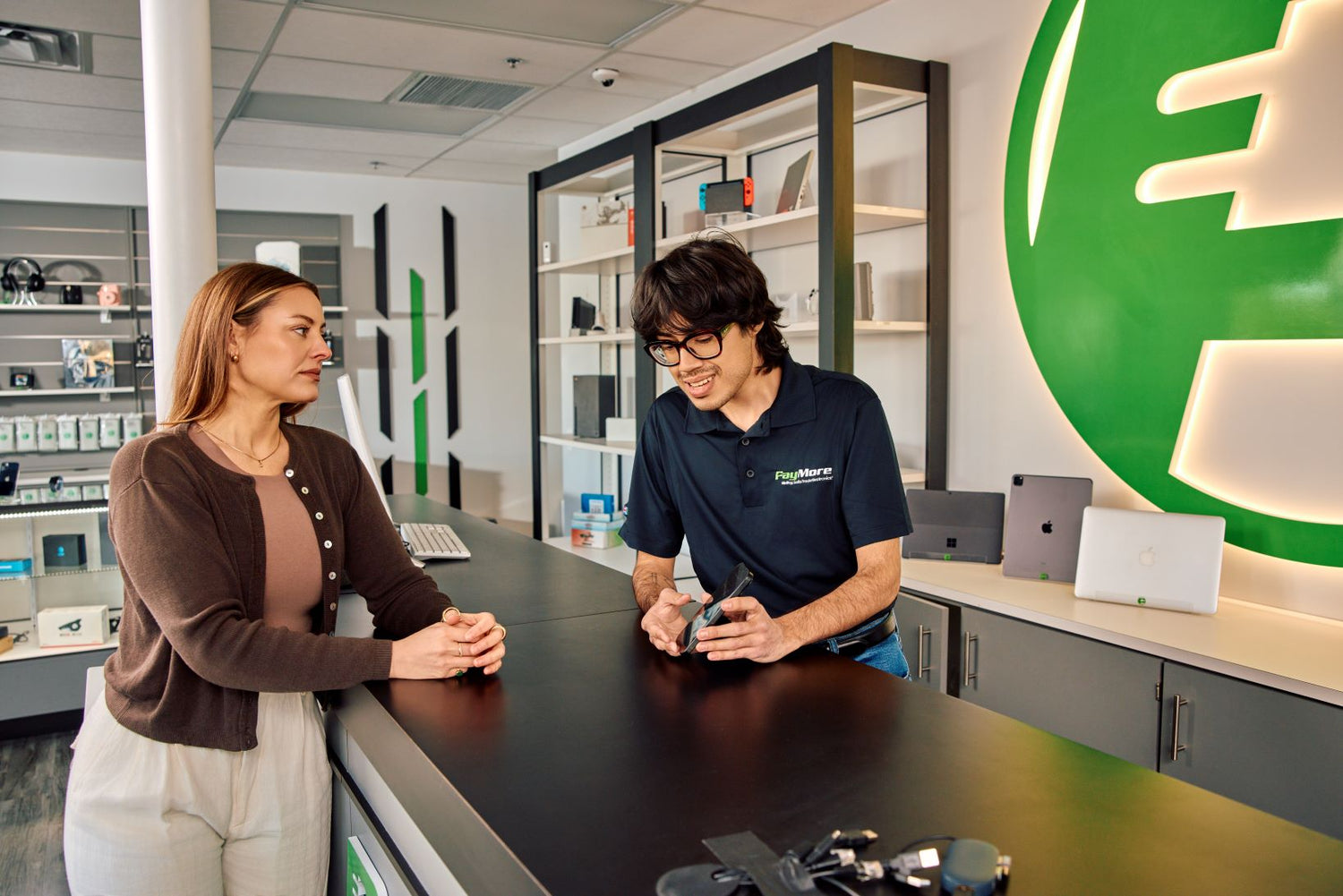 paymore employee inspecting electronics